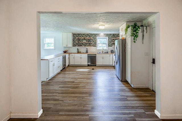 13 Thomas, Williamston, SC 29697 - kitchen with appliances with stainless steel finishes, beverage cooler, white cabinets, a textured ceiling, and dark wood finished floors