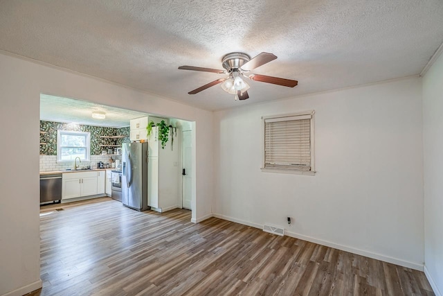 13 Thomas, Williamston, SC 29697 - empty room featuring wood finished floors, ceiling fan, and a textured ceiling