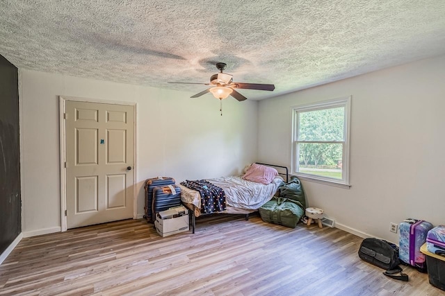 13 Thomas, Williamston, SC 29697 - bedroom featuring wood finished floors, a textured ceiling, and a ceiling fan