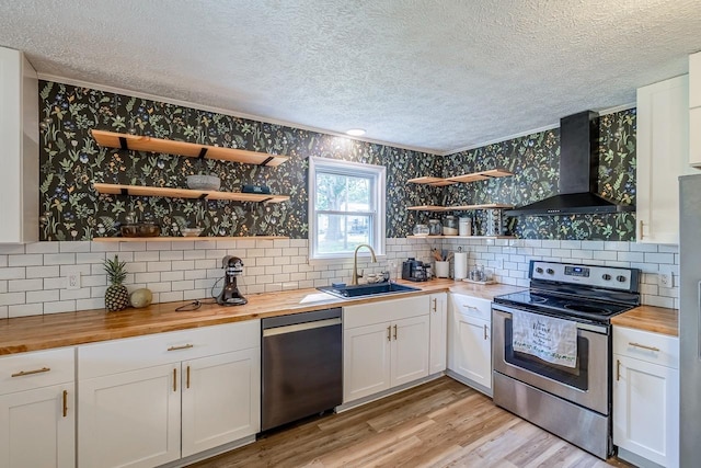 13 Thomas, Williamston, SC 29697 - kitchen featuring wooden counters, stainless steel appliances, wall chimney exhaust hood, a textured ceiling, and wallpapered walls