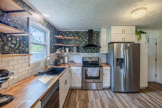 13 Thomas, Williamston, SC 29697 - kitchen featuring wall chimney exhaust hood, appliances with stainless steel finishes, wooden counters, open shelves, and a textured ceiling