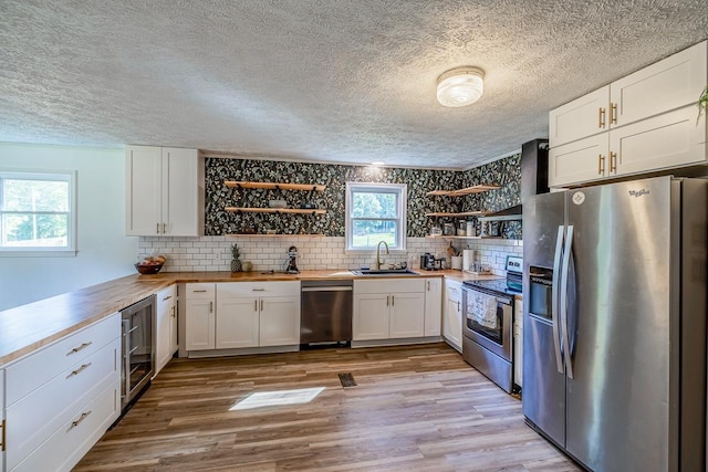 13 Thomas, Williamston, SC 29697 - kitchen featuring stainless steel appliances, open shelves, beverage cooler, butcher block countertops, and white cabinets
