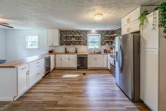 13 Thomas, Williamston, SC 29697 - kitchen featuring appliances with stainless steel finishes, butcher block counters, wine cooler, open shelves, and a peninsula
