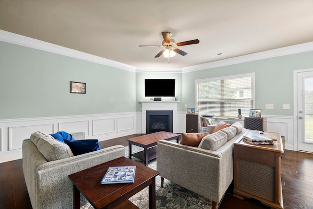 415 Bridge Xing, Simpsonville, SC 29681 - living room featuring crown molding, ceiling fan, wainscoting, a fireplace, and dark wood-style floors