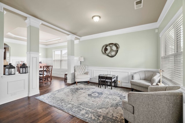 415 Bridge Xing, Simpsonville, SC 29681 - living room featuring decorative columns, crown molding, dark wood-style flooring, a decorative wall, and wainscoting