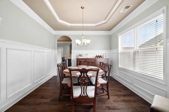 415 Bridge Xing, Simpsonville, SC 29681 - dining space featuring a decorative wall, a tray ceiling, arched walkways, a chandelier, and dark wood-type flooring