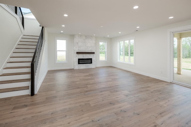 3617 Pennington, Greer, SC 29651 - unfurnished living room featuring healthy amount of natural light, stairs, recessed lighting, wood finished floors, and a tiled fireplace