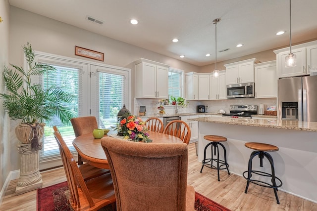 119 W Caylee, Chesnee, SC 29323 - kitchen with appliances with stainless steel finishes, decorative backsplash, light wood-type flooring, white cabinetry, and recessed lighting