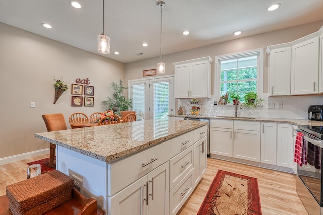 119 W Caylee, Chesnee, SC 29323 - kitchen with appliances with stainless steel finishes, light wood-style floors, a center island, tasteful backsplash, and recessed lighting