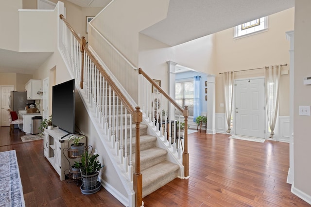 514 Collingsworth, Greenville, SC 29615 - foyer entrance with a towering ceiling, healthy amount of natural light, wainscoting, wood finished floors, and stairway