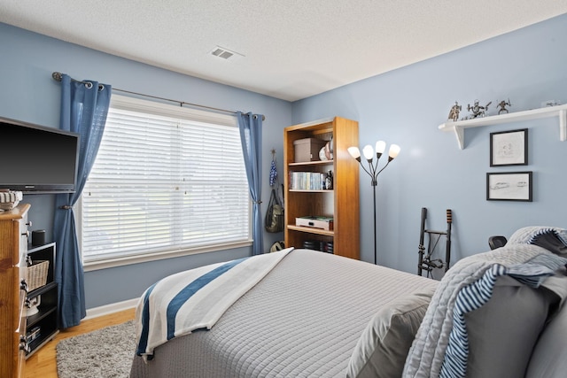 514 Collingsworth, Greenville, SC 29615 - bedroom featuring wood finished floors, multiple windows, and a textured ceiling