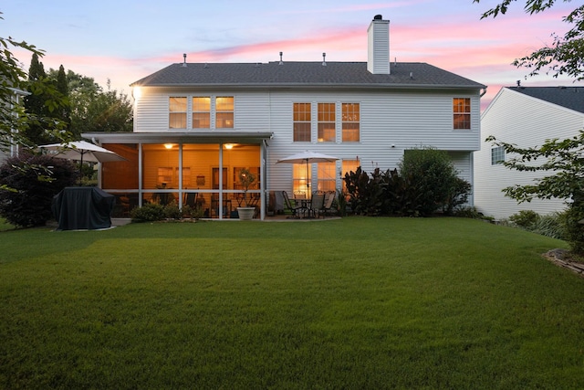 514 Collingsworth, Greenville, SC 29615 - back of property at dusk featuring a lawn, a chimney, a sunroom, and a patio