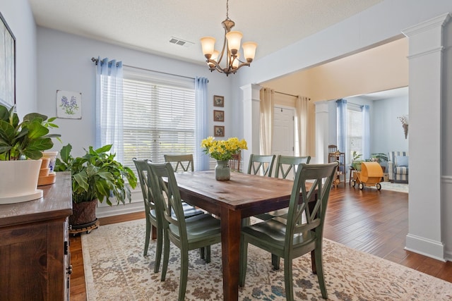 514 Collingsworth, Greenville, SC 29615 - dining room featuring a chandelier, wood finished floors, and decorative columns