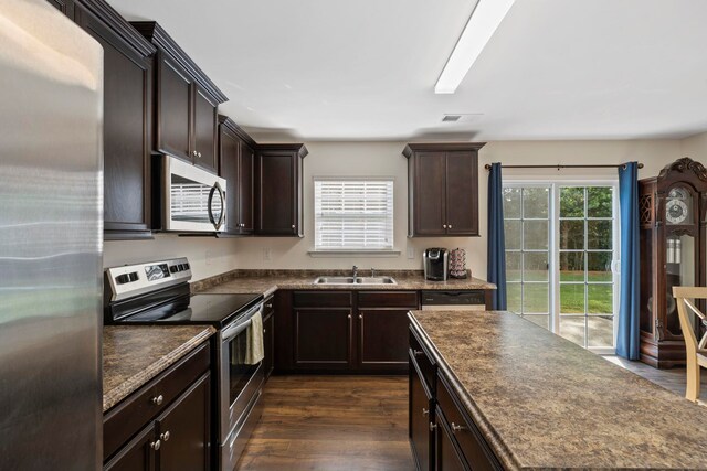 714 Cremello, Moore, SC 29369 - kitchen with stainless steel appliances, dark countertops, dark brown cabinetry, and dark wood-style flooring