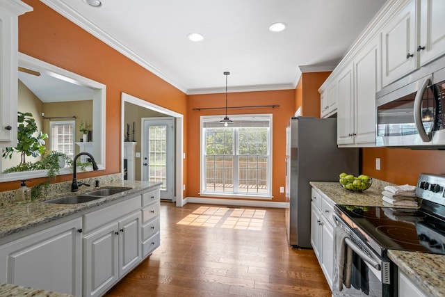 802 Wheat, Greer, SC 29651 - kitchen with appliances with stainless steel finishes, white cabinetry, ornamental molding, dark wood-style flooring, and pendant lighting