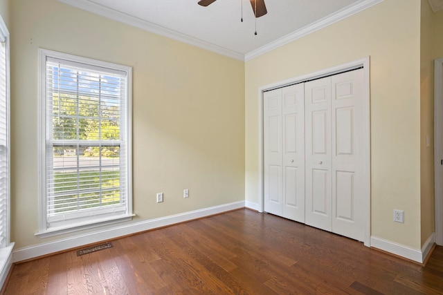 802 Wheat, Greer, SC 29651 - unfurnished bedroom featuring ornamental molding, dark wood-style floors, a closet, and a ceiling fan