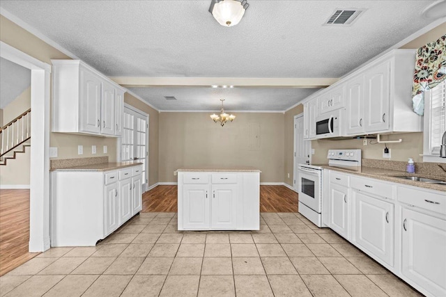 298 Askew, Union, SC 29379 - kitchen with white appliances, a chandelier, white cabinetry, a textured ceiling, and light tile patterned floors