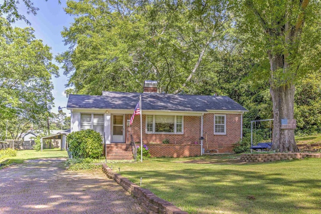 1205 Clary, Gaffney, SC 29340 - view of front of house featuring a front yard, brick siding, and a chimney