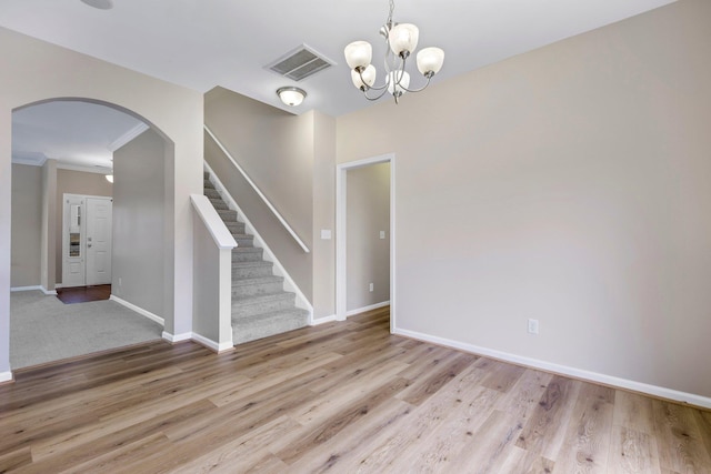 463 Lynnell, Moore, SC 29369 - empty room with arched walkways, light wood finished floors, a chandelier, stairway, and crown molding