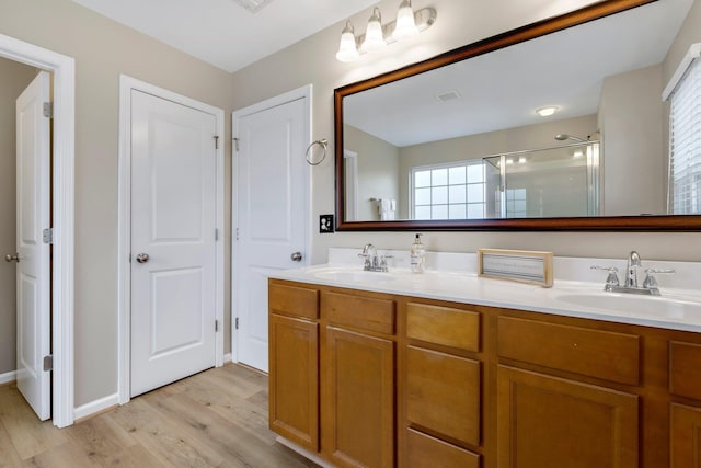 463 Lynnell, Moore, SC 29369 - bathroom featuring wood finished floors, a shower with shower door, and double vanity