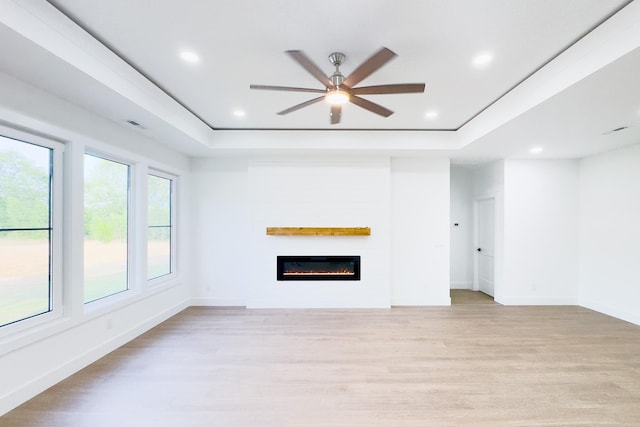 634 N Green Riv, Gaffney, SC 29341 - unfurnished living room with a raised ceiling, light wood-style floors, a glass covered fireplace, recessed lighting, and ceiling fan