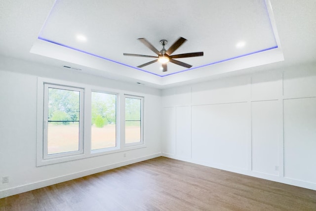 634 N Green Riv, Gaffney, SC 29341 - unfurnished room with a tray ceiling, ceiling fan, light wood-style flooring, and recessed lighting