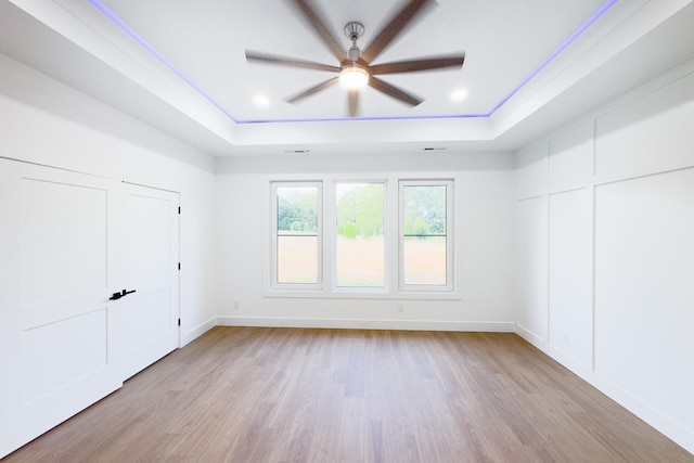 634 N Green Riv, Gaffney, SC 29341 - unfurnished bedroom featuring a tray ceiling, light wood-style floors, and ceiling fan