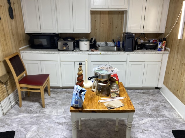 414 W Buford, Gaffney, SC 29340 - kitchen featuring wood walls, black microwave, light countertops, and white cabinets