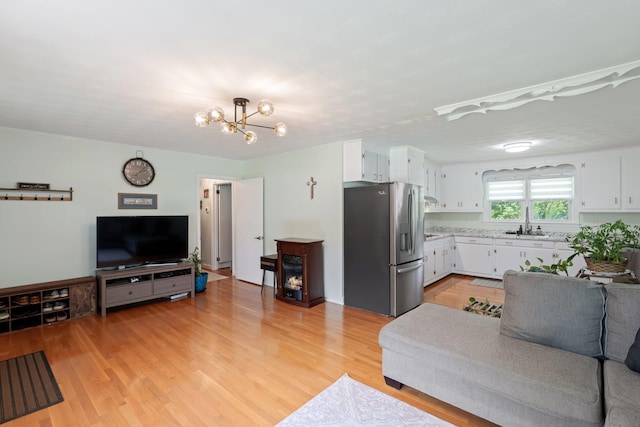 1142 Cooper Brg, Woodruff, SC 29388 - living area featuring light wood-style flooring and a chandelier