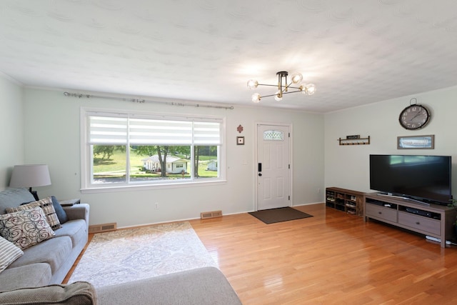 1142 Cooper Brg, Woodruff, SC 29388 - living room featuring a chandelier, light wood-style flooring, and crown molding