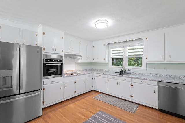 1142 Cooper Brg, Woodruff, SC 29388 - kitchen with appliances with stainless steel finishes, light wood-type flooring, white cabinets, and light stone counters