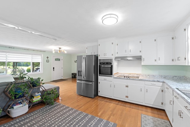 1142 Cooper Brg, Woodruff, SC 29388 - kitchen with stainless steel appliances, under cabinet range hood, light wood finished floors, and white cabinetry