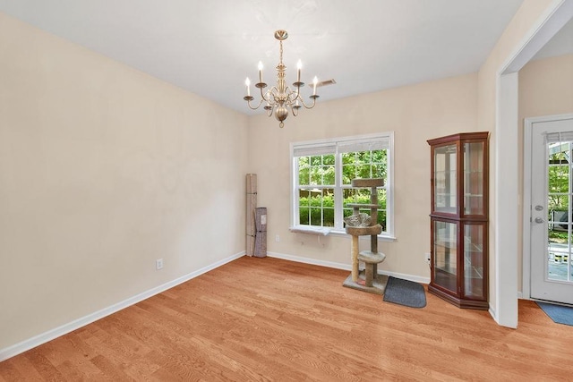 232 N Hamlet, Moore, SC 29369 - unfurnished dining area with wood finished floors, a chandelier, and plenty of natural light