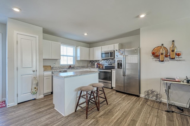 906 Hattie Ln, Lyman, SC 29365 - kitchen with appliances with stainless steel finishes, wood finished floors, white cabinetry, and recessed lighting