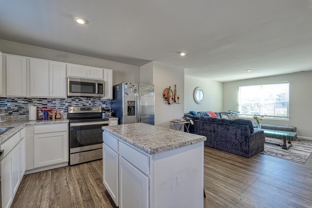 906 Hattie Ln, Lyman, SC 29365 - kitchen with appliances with stainless steel finishes, wood finished floors, open floor plan, white cabinetry, and recessed lighting