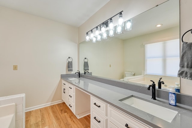 233 Summerfield, Moore, SC 29369 - bathroom with double vanity, a garden tub, and wood finished floors