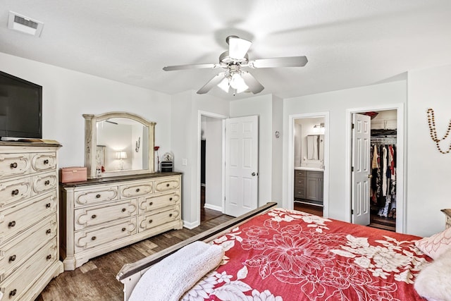 308 Juniper Leaf, Greer, SC 29651 - bedroom with dark wood-style floors, a spacious closet, connected bathroom, a ceiling fan, and a closet
