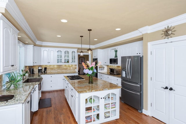 403 Barrington Park, Greer, SC 29650 - kitchen with stainless steel appliances, glass insert cabinets, a kitchen island, wood finished floors, and ornamental molding