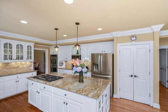 403 Barrington Park, Greer, SC 29650 - kitchen featuring appliances with stainless steel finishes, decorative backsplash, glass insert cabinets, a center island, and light wood finished floors