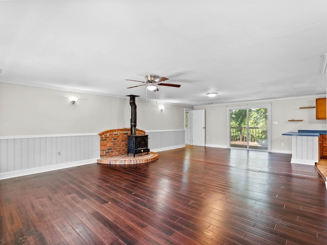113 Commodore, Duncan, SC 29334 - unfurnished living room with a wood stove, hardwood / wood-style flooring, a ceiling fan, and wainscoting