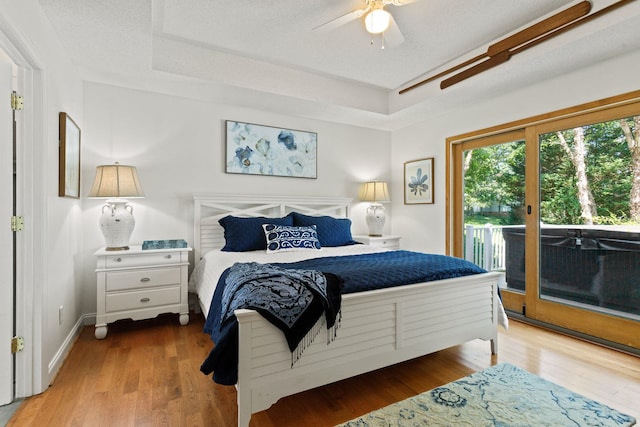 436 S Lakeview, Duncan, SC 29334 - bedroom with access to exterior, a tray ceiling, wood finished floors, and ceiling fan