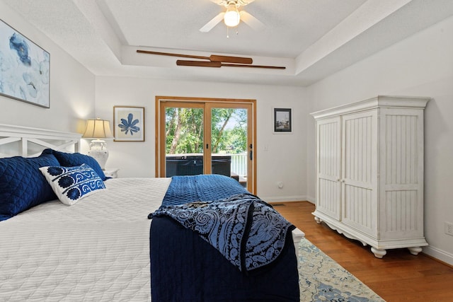 436 S Lakeview, Duncan, SC 29334 - bedroom featuring access to outside, a tray ceiling, wood finished floors, and ceiling fan