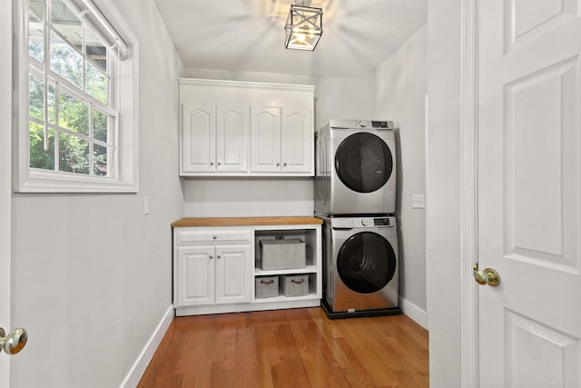 436 S Lakeview, Duncan, SC 29334 - washroom with stacked washing machine and dryer, cabinet space, and wood finished floors