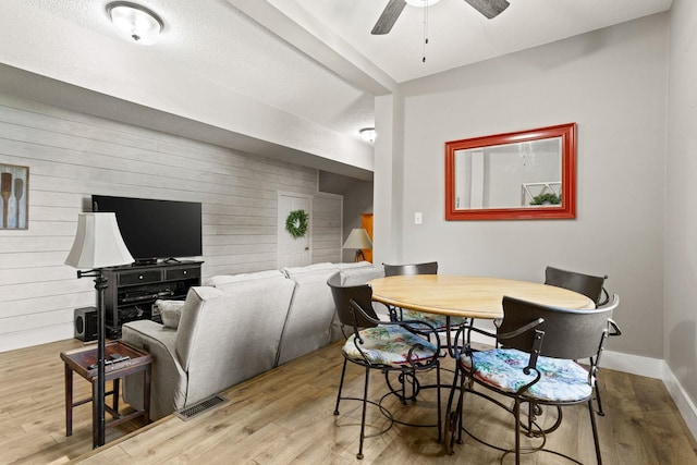 436 S Lakeview, Duncan, SC 29334 - dining room with wood walls, a ceiling fan, wood finished floors, and an accent wall