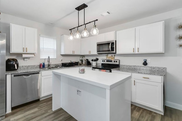 226 Christopher St, Duncan, SC 29334 - kitchen with appliances with stainless steel finishes, white cabinetry, light countertops, and dark wood-style flooring