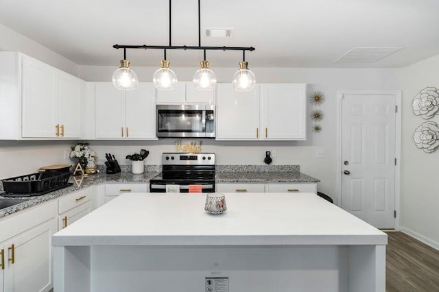 226 Christopher St, Duncan, SC 29334 - kitchen with stainless steel appliances, light countertops, white cabinetry, dark wood-style floors, and a center island