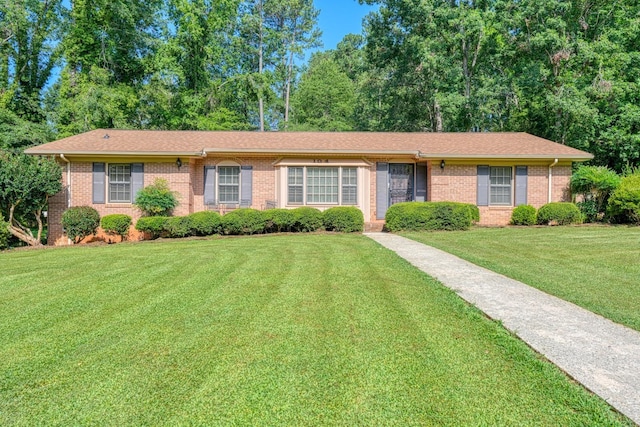 104 Pine, Laurens, SC 29360 - ranch-style house featuring brick siding, a front yard, and a shingled roof