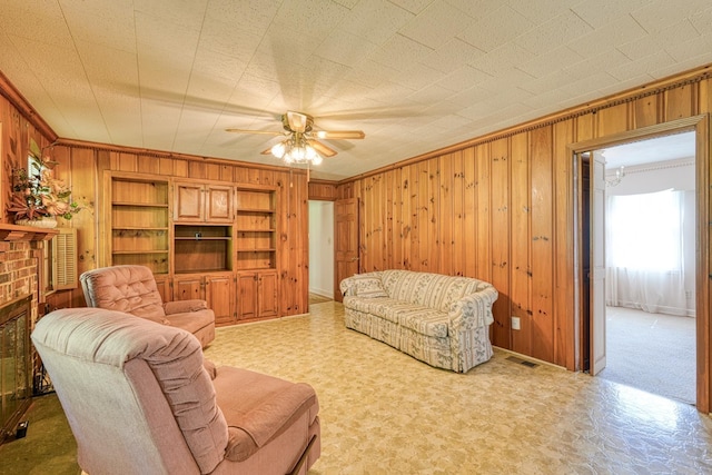 104 Pine, Laurens, SC 29360 - living area featuring wooden walls, ceiling fan, and ornamental molding