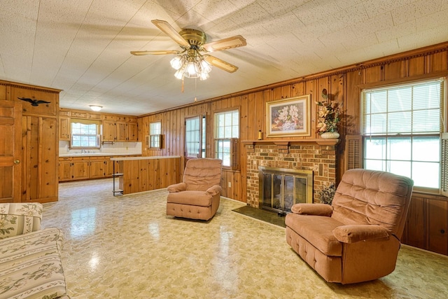 104 Pine, Laurens, SC 29360 - living area with wood walls, ceiling fan, and a fireplace