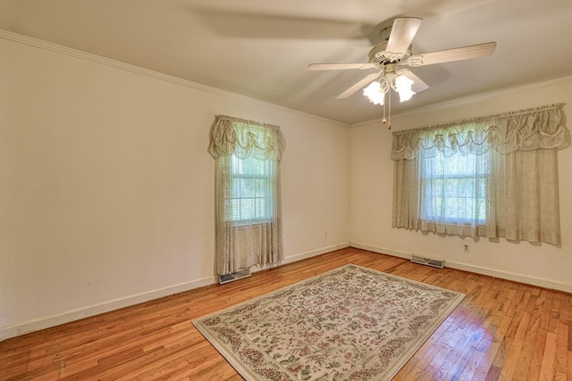 104 Pine, Laurens, SC 29360 - spare room with plenty of natural light, wood finished floors, ornamental molding, and a ceiling fan